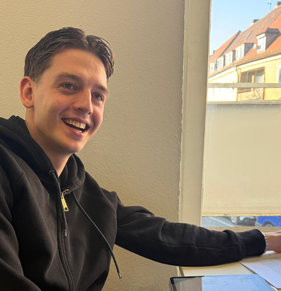 junger Mann lächelnd beim Lernen